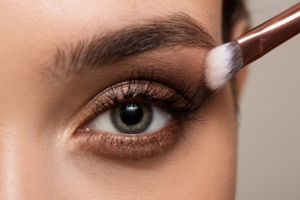 Female open eye close up. Eye makeup for eyebrows and eyelashes.